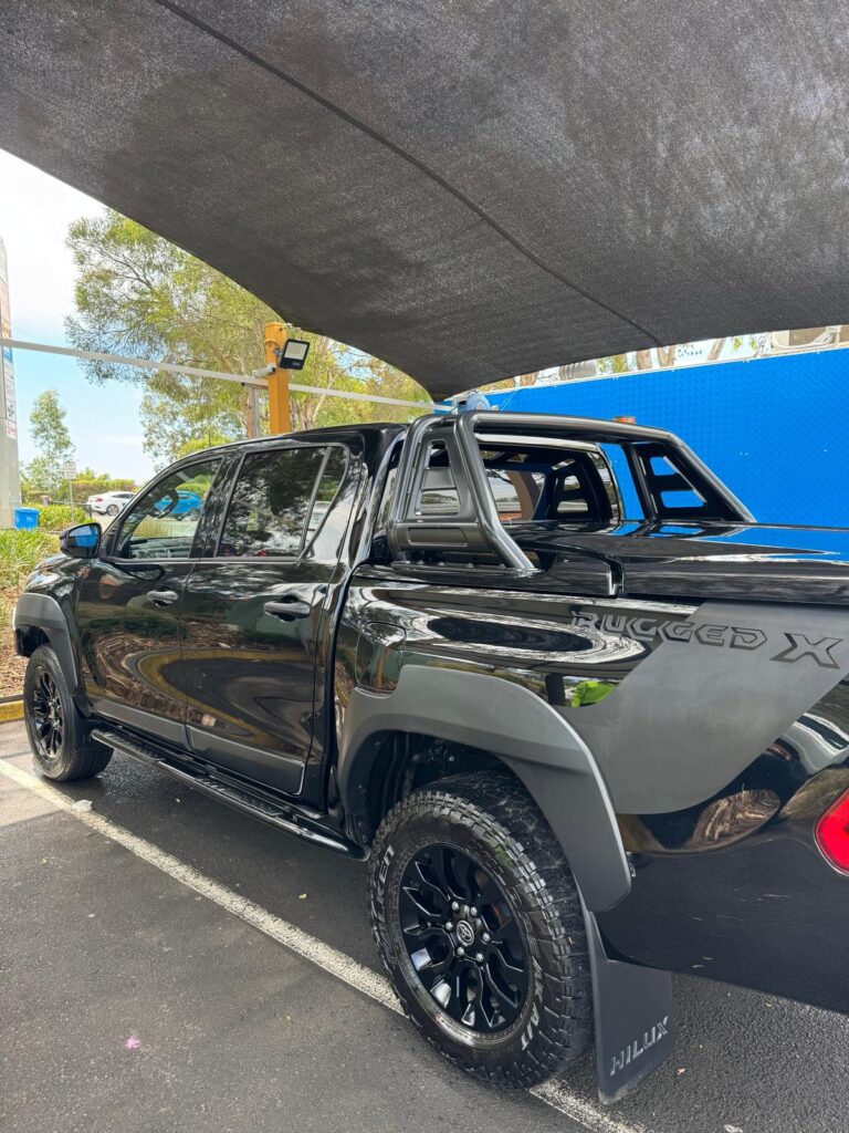 Glossy black ute exterior after professional detailing