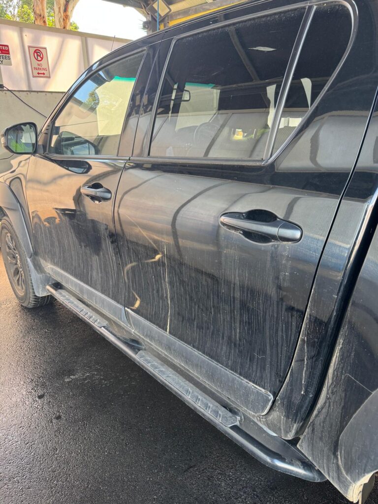Heavily soiled black ute exterior before detailing