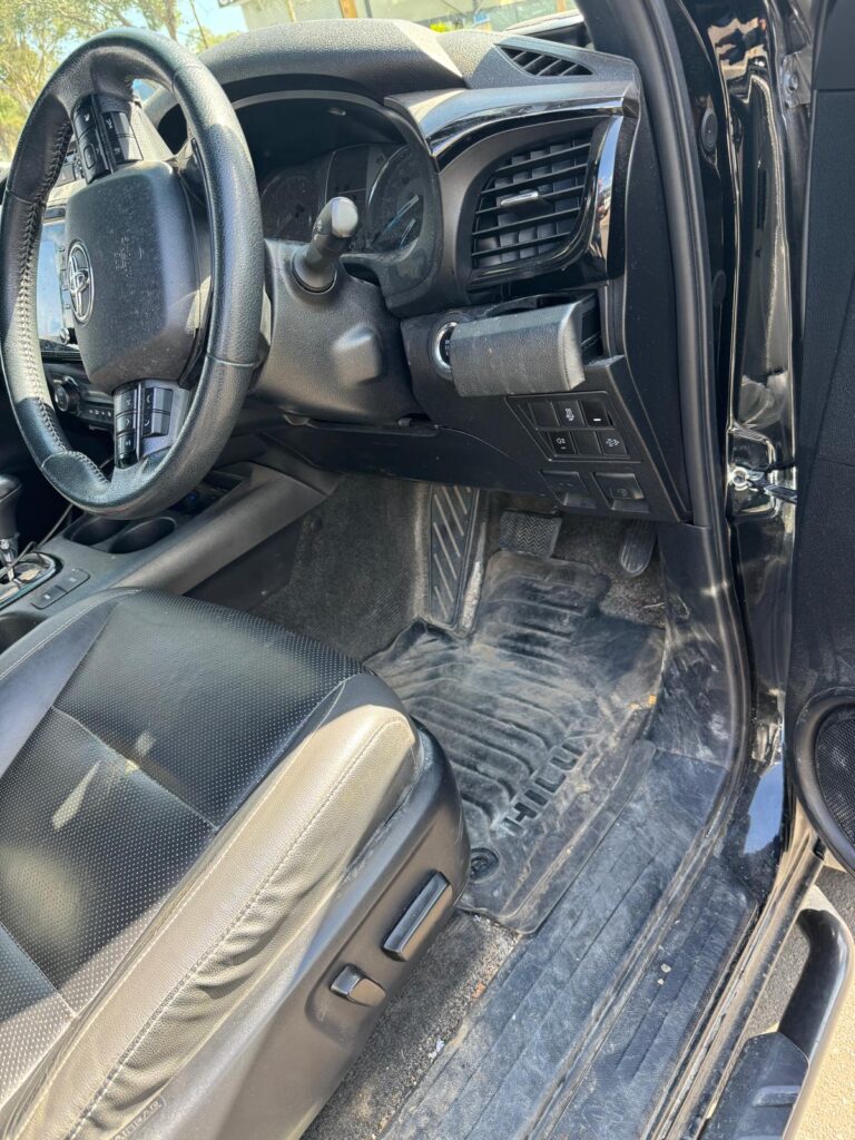 Dusty and soiled ute driver footwell before interior detailing